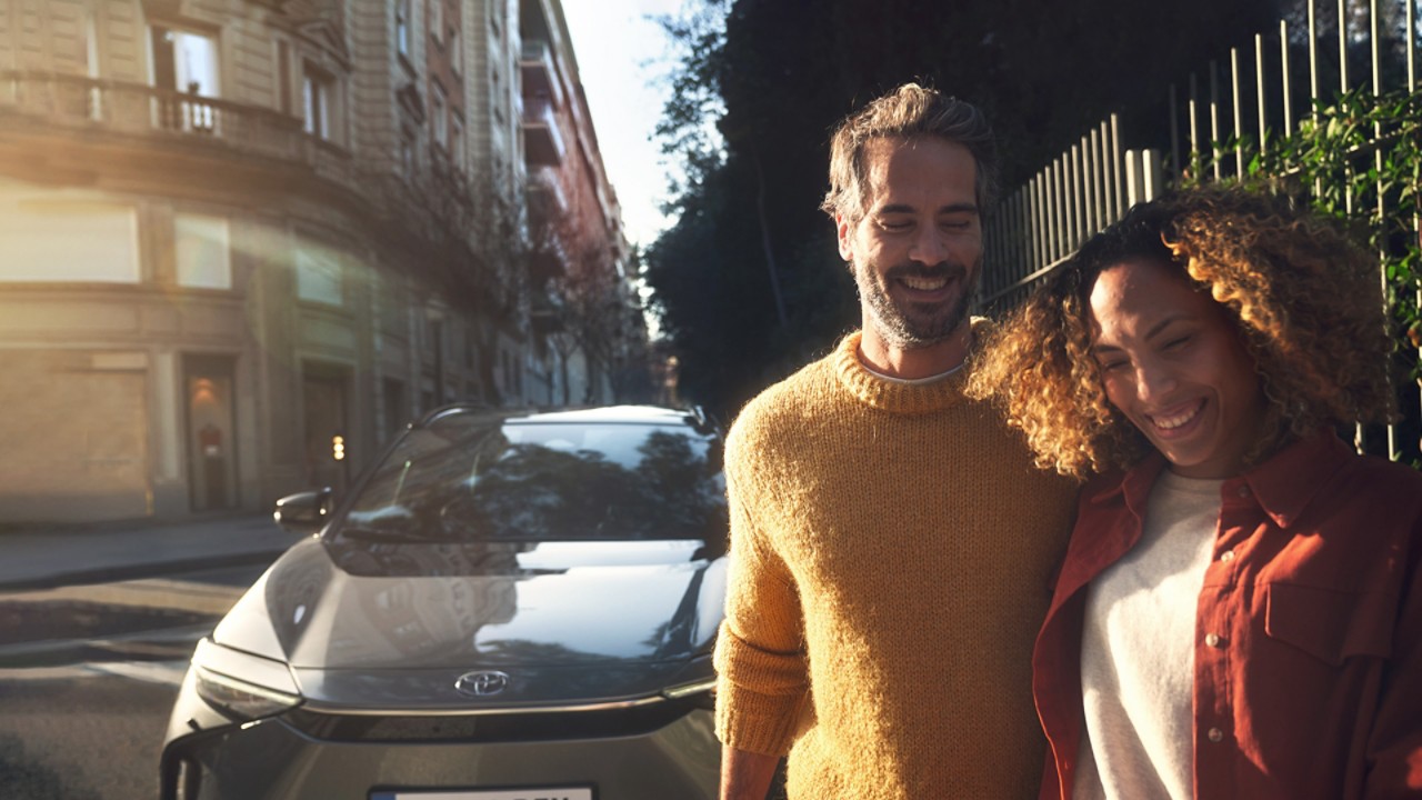 Happy couple with Toyota car 